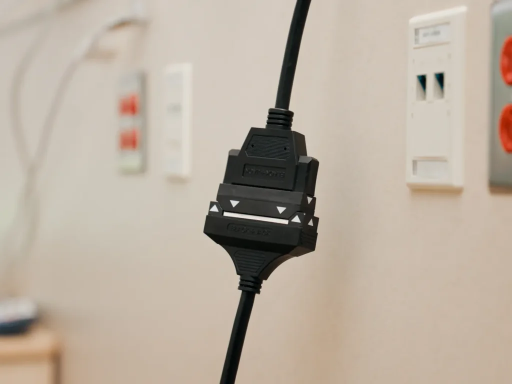 The two halves of a BlackJack cable joined in front of a headwall with outlets and data ports.