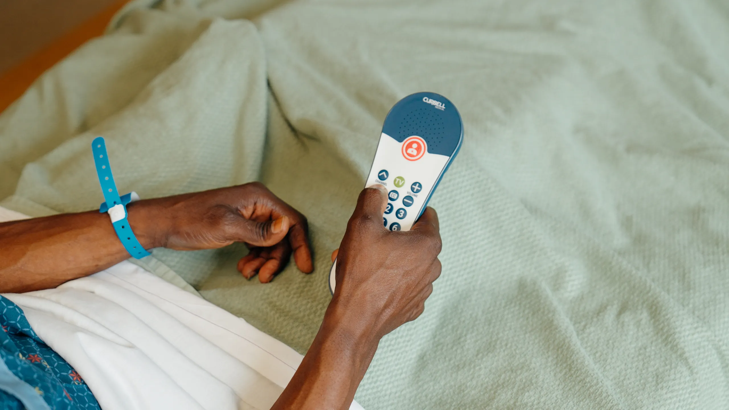 Patient hands holding a pillow speaker