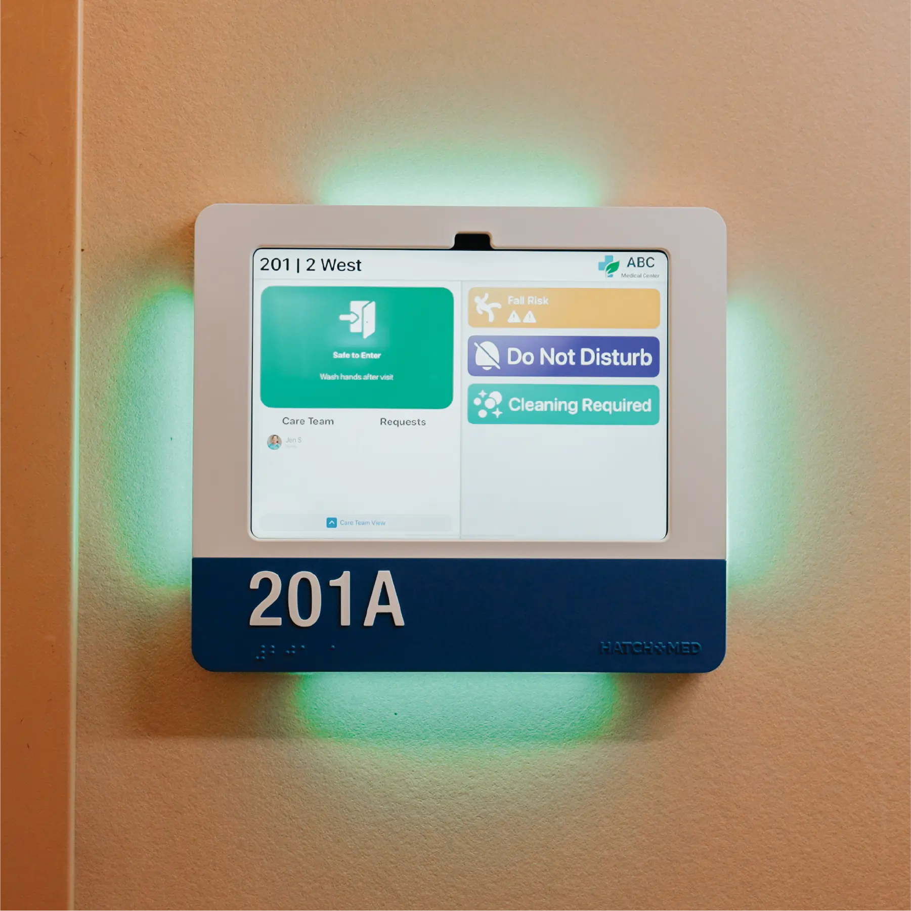 A landscape HallMonitor with a navy accent plate and room number 201A, glowing green.